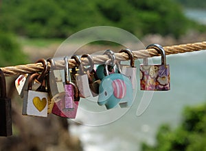 The Color love padlock locked on rope bridgeÃÂ bridge